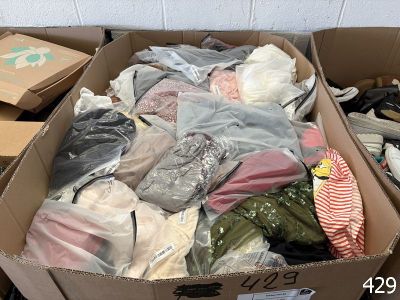 a cardboard box filled with clothes and other items