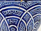 a blue and white bowl with a lid on a table