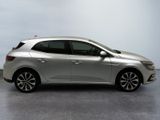 the silver car is parked on the concrete floor in the room