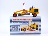 a yellow toy bulldozer sitting on top of a box