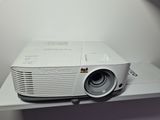 a white projector sitting on top of a white table