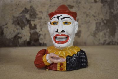 a clown figurine that is sitting on a table