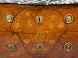 a marble top on a wooden chest of drawers