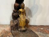 a statue of a woman sitting on a rock next to a statue of a man
