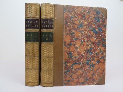 two books sitting on top of each other on a white surface