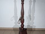 a table with a lamp on top of it on a tiled floor