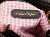 a pink and white checkered purse with a name tag on it
