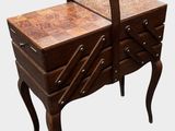 a small wooden dresser with a mirror on top of it