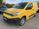 a yellow van parked in a parking lot next to other cars