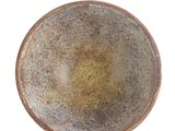 an overhead view of a bowl on a white surface