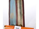 a wooden case with a pen in it on a white surface