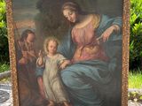 une peinture ancienne représentant une femme tenant un enfant sur ses genoux