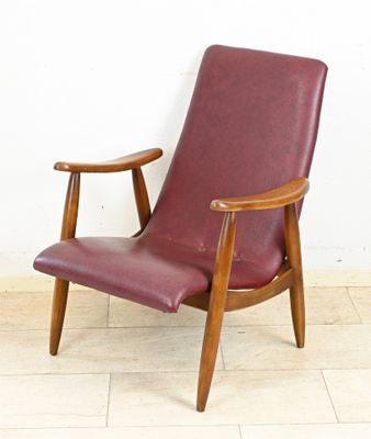 an image of a red leather chair against a white wall