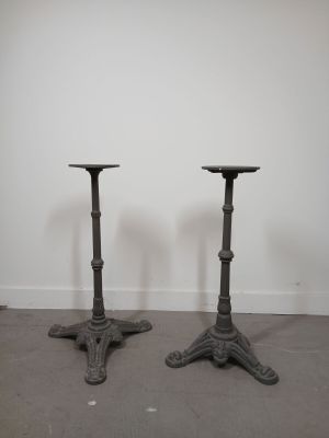 pair of antique cast iron candlesticks in the manner of person
