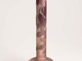 the vase is made of glass and has a brown base