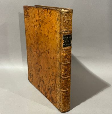 an old book sitting on top of a white surface