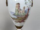 a vase with a picture of a castle on it