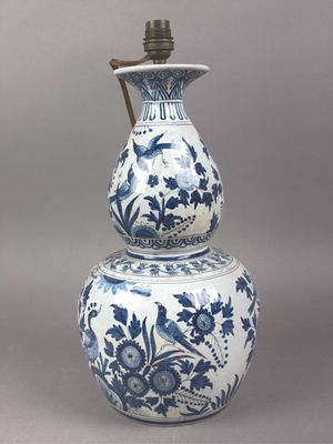 an antique blue and white vase with a handle on top of it