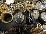 a pile of gold and silver jewelry on a table
