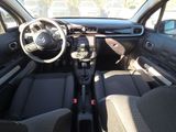 the interior of a small car with a steering wheel and dashboard