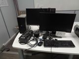 a desk with a computer, keyboard, mouse, and monitor on it