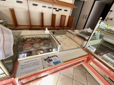 a display case filled with donuts in a bakery