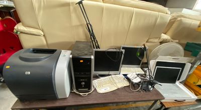a lot of computer equipment on a table in a room