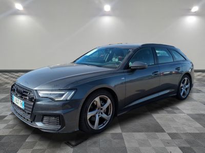 a grey audi wagon parked on a checkered tile floor