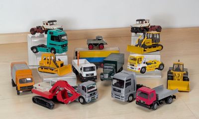 a lot of toy trucks that are sitting on the floor