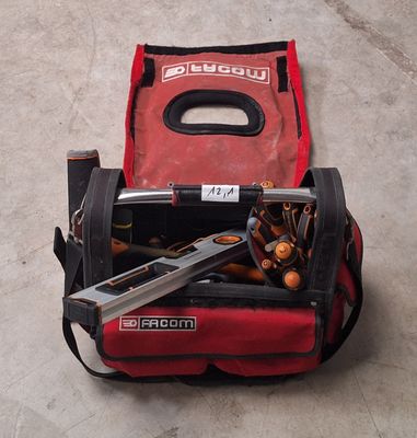 a tool bag with tools inside of it on the floor