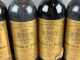 four bottles of wine are lined up on a table