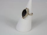 a close up of a silver ring with a black stone on it