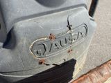 a close up of a car ' s emblem on the side of the road
