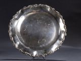 silver plate on stand on grey background with black background