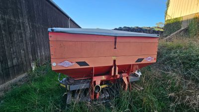 a red wagon that is sitting on the side of the road