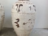 two vases sitting next to each other on the floor