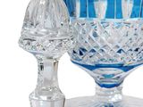 a blue glass vase and a glass salt shaker on a white background