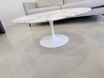 a marble table with a white base in a living room