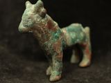 a small figurine of a dog on a black background