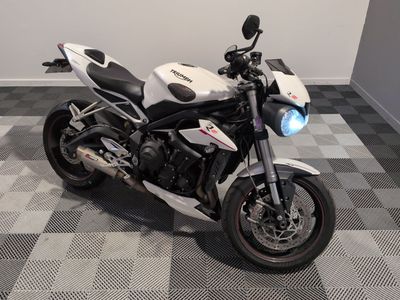 a white and black motorcycle parked on a checkered floor