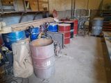 a room with a lot of barrels and other items on the floor