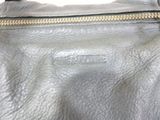 leather handbag with gold zippers on a white background