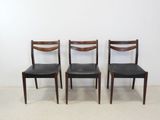set of four dining chairs with black leather upholstered seats