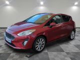a red ford fiesta parked on a checkered tile floor
