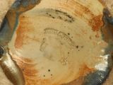 a close up of a brown and blue plate on a table