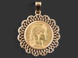 a gold coin pendant with a woman ' s head in the center