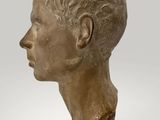 bust of a man in profile with a necklace on his neck