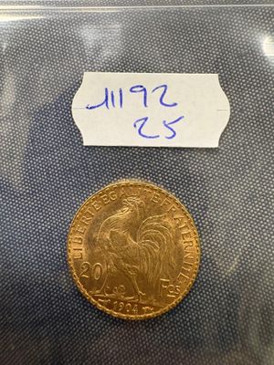 a close up of a gold coin with a label on it