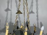 a chandelier with candles hanging from it ' s ceiling