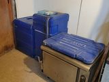 two blue coolers sitting next to each other in a room
